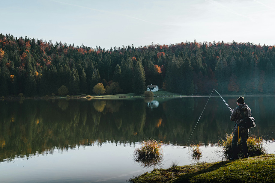 A man fishing by a lake.